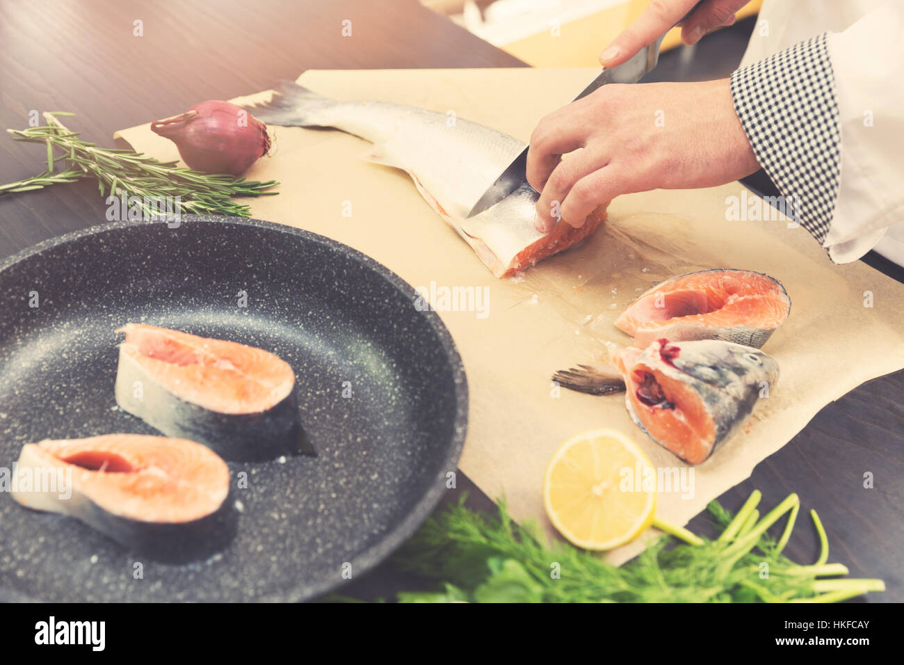 seafood - chef slicing salmon fish for preparing Stock Photo