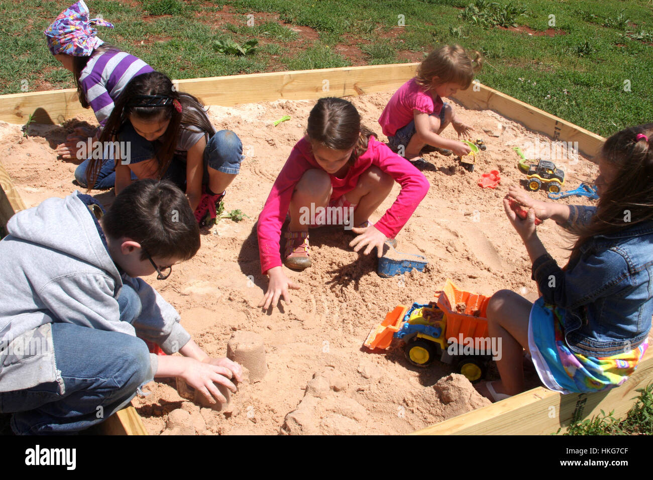 Children playing at sand box Stock Photo - Alamy