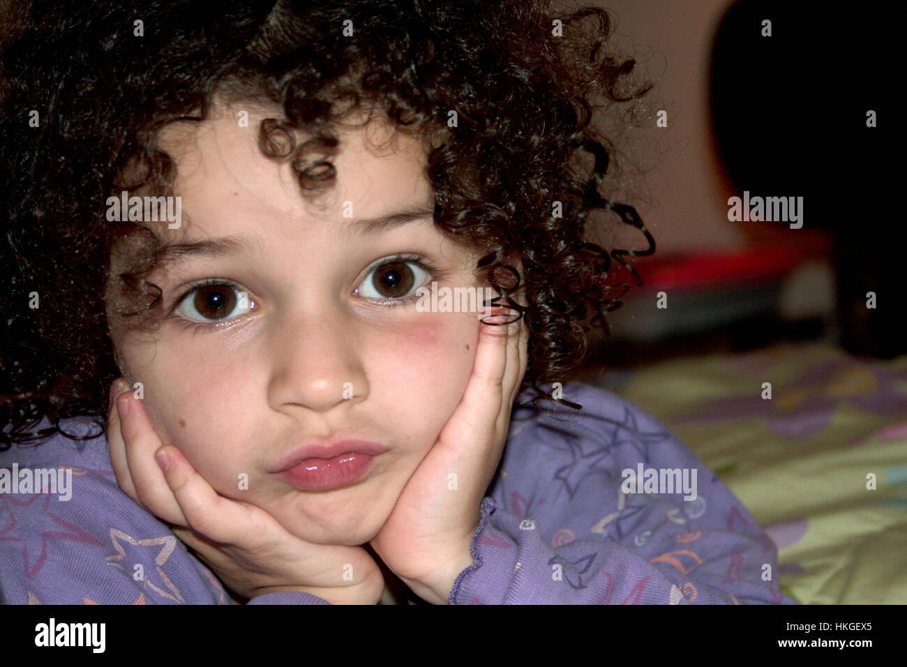 Little Caucasian Girl With Natural Curly Hair Making A Funny Cute