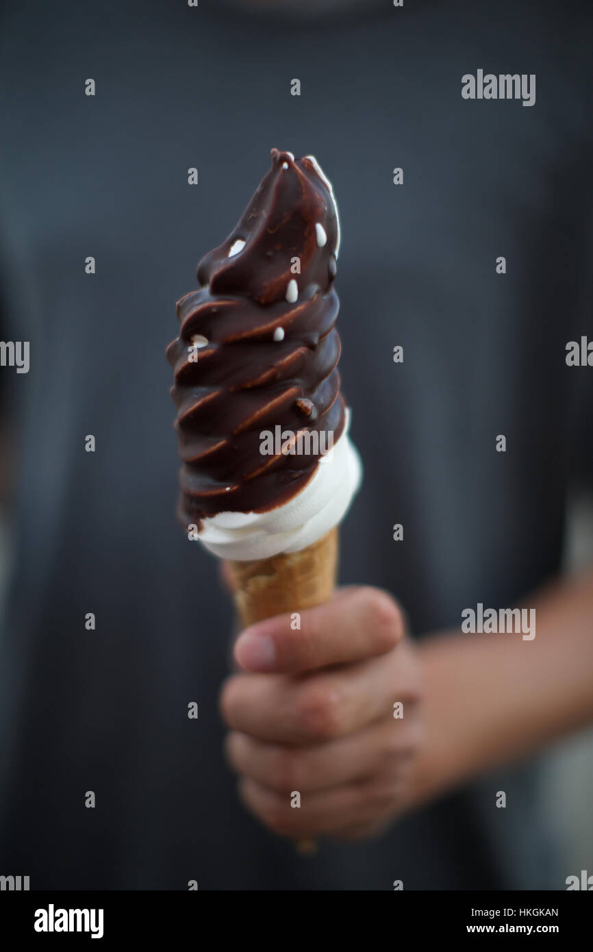 hand holding softice cone with chocolate sprinkle. sweet food, ice