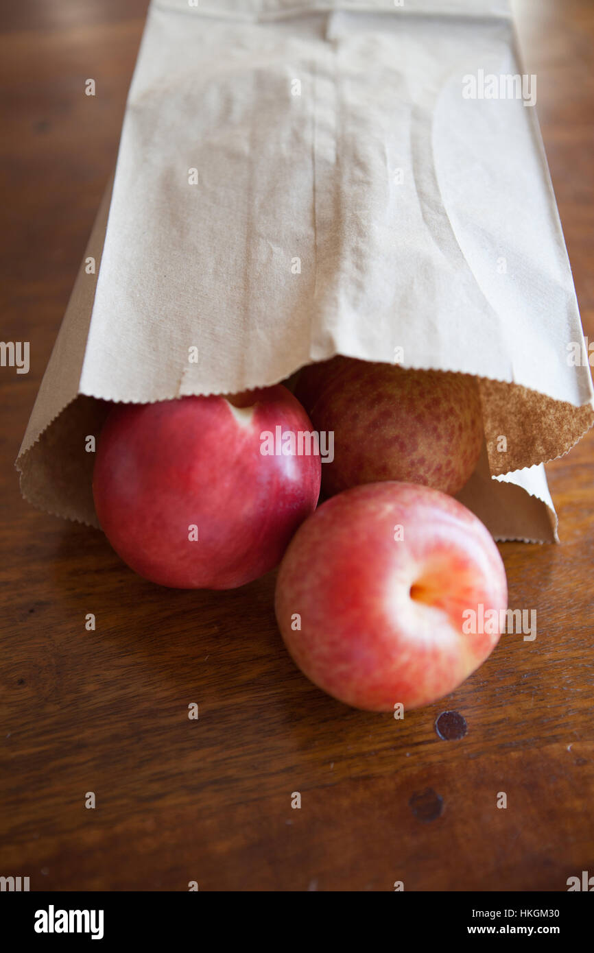 Brown paper bag with ripe plums Stock Photo Alamy