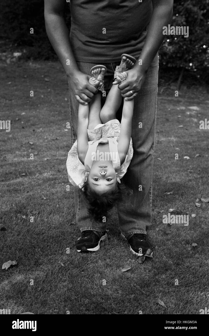 Father swings child upside down Stock Photo Alamy