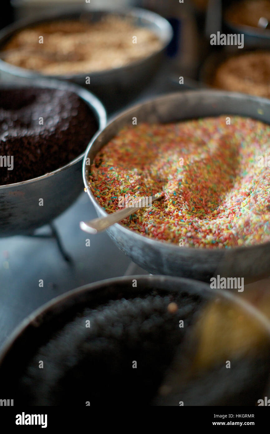 bowl of confetti sprinkles. spoon, container, sweet, food Stock Photo