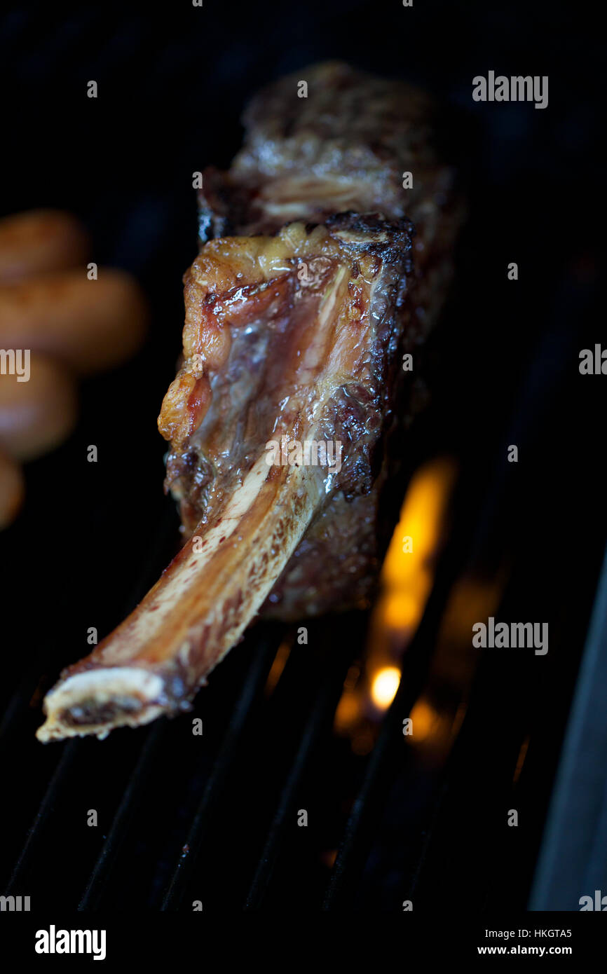close up of bone beef on barbecue. gourmet, greasy, meat, food Stock