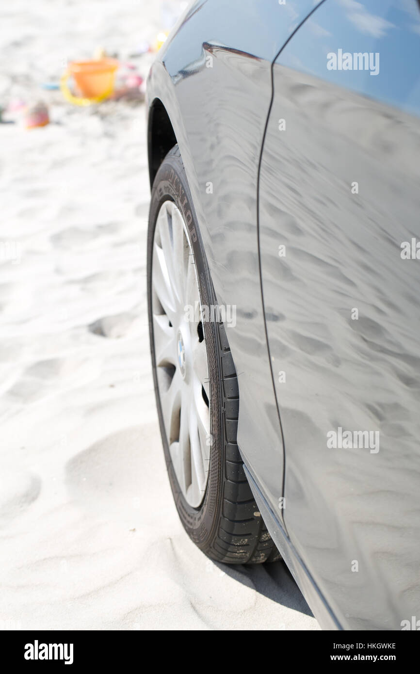 wheel of car at beach. sand, vehicle, reflection, tyre. Stock Photo