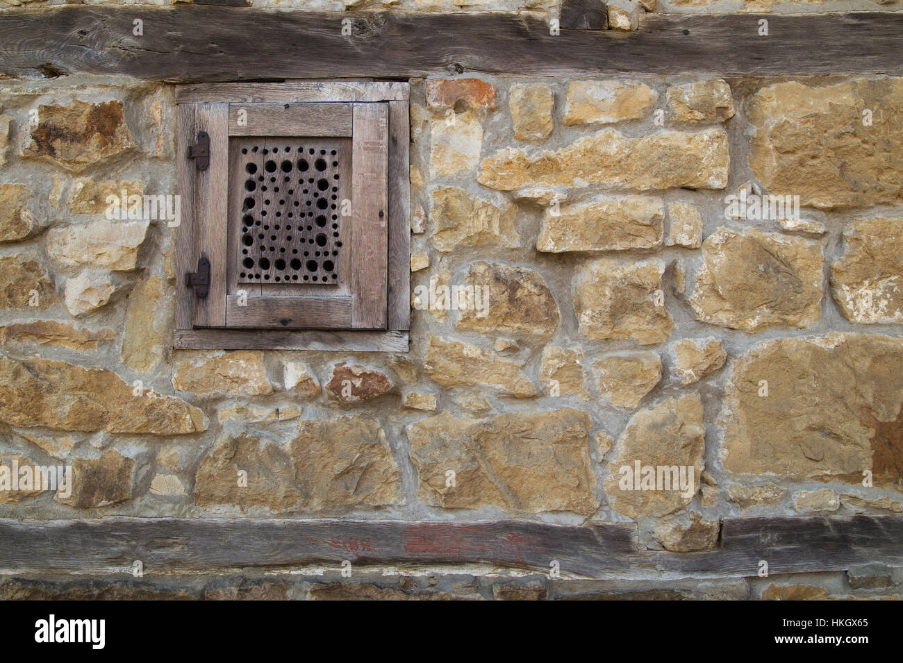 Wooden window on stone wall Stock Photo - Alamy