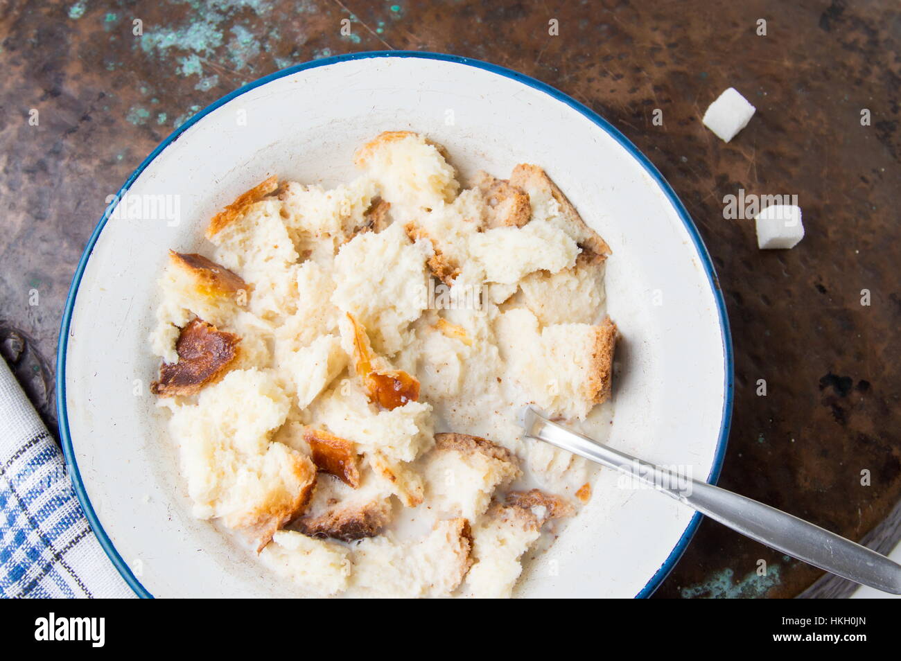 Bread dipped into warm milk on a plate Stock Photo