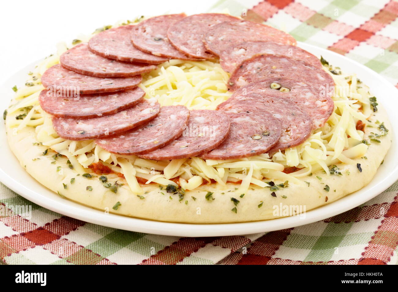 ready to bake delicious rustic salami and cheese pizza Stock Photo - Alamy