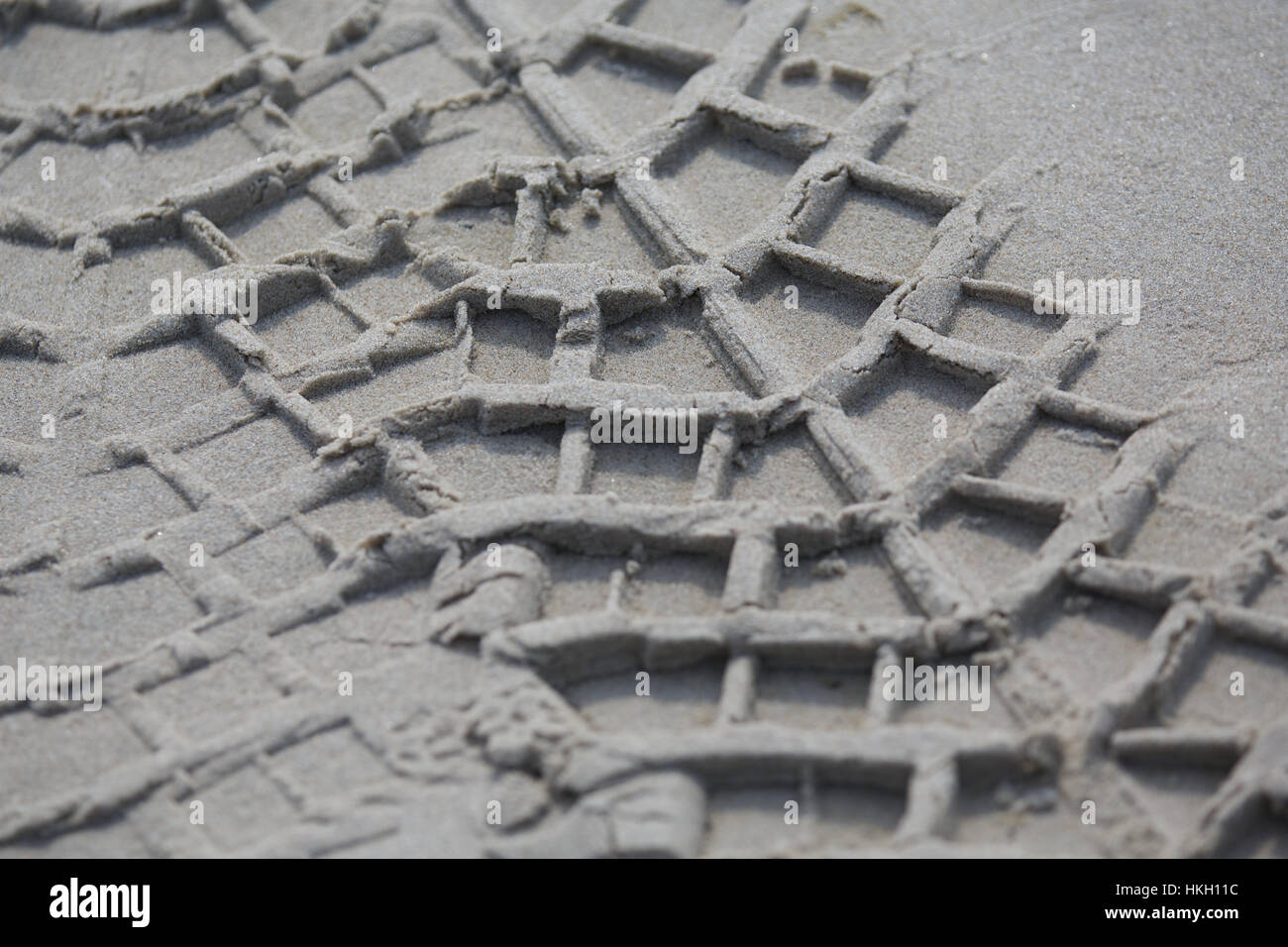tyre track on wet sand. pattern, trail, beach, holiday. Stock Photo