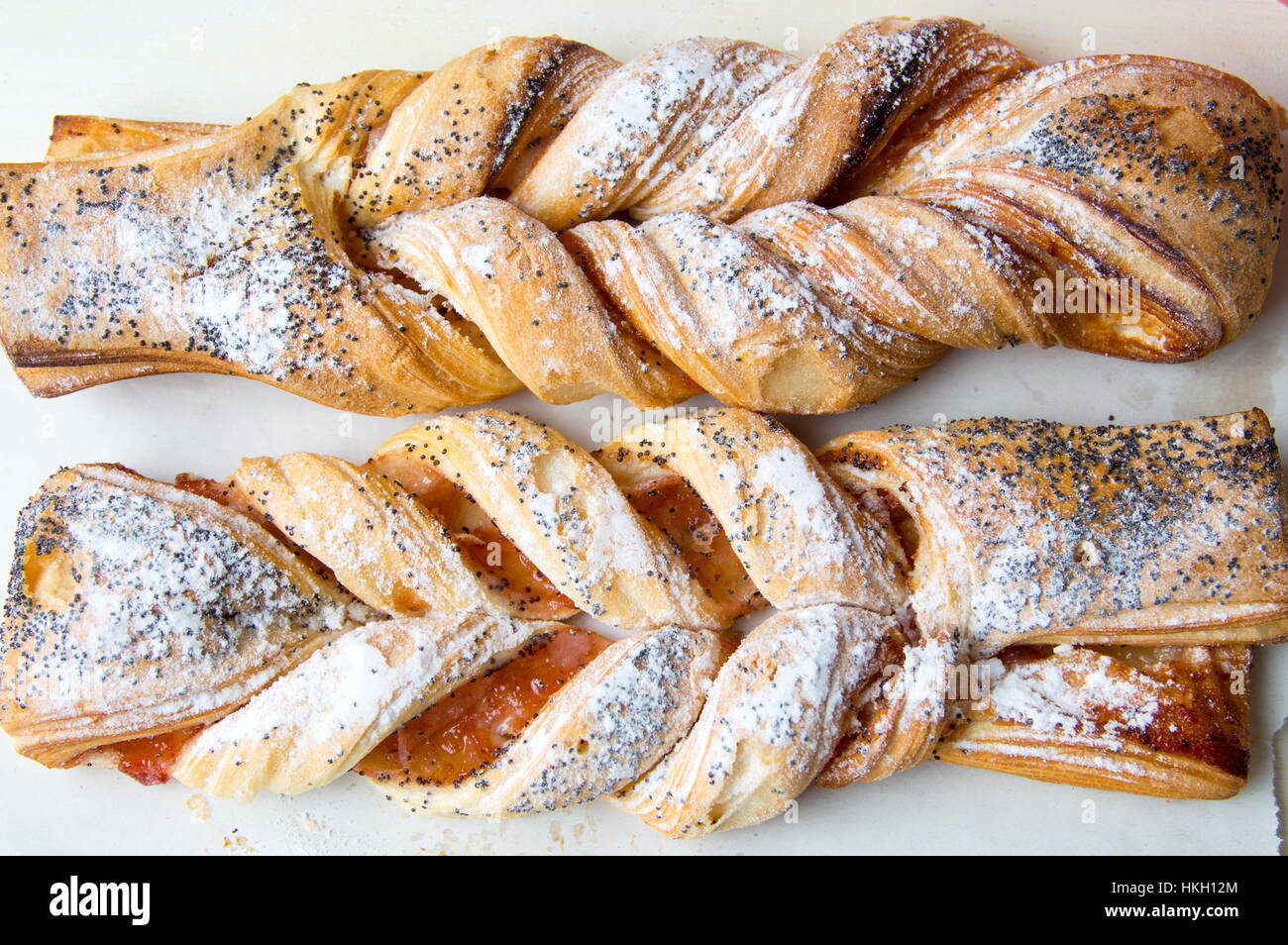 Braided sweet puff pastry sprinkled with poppy seeds Stock Photo