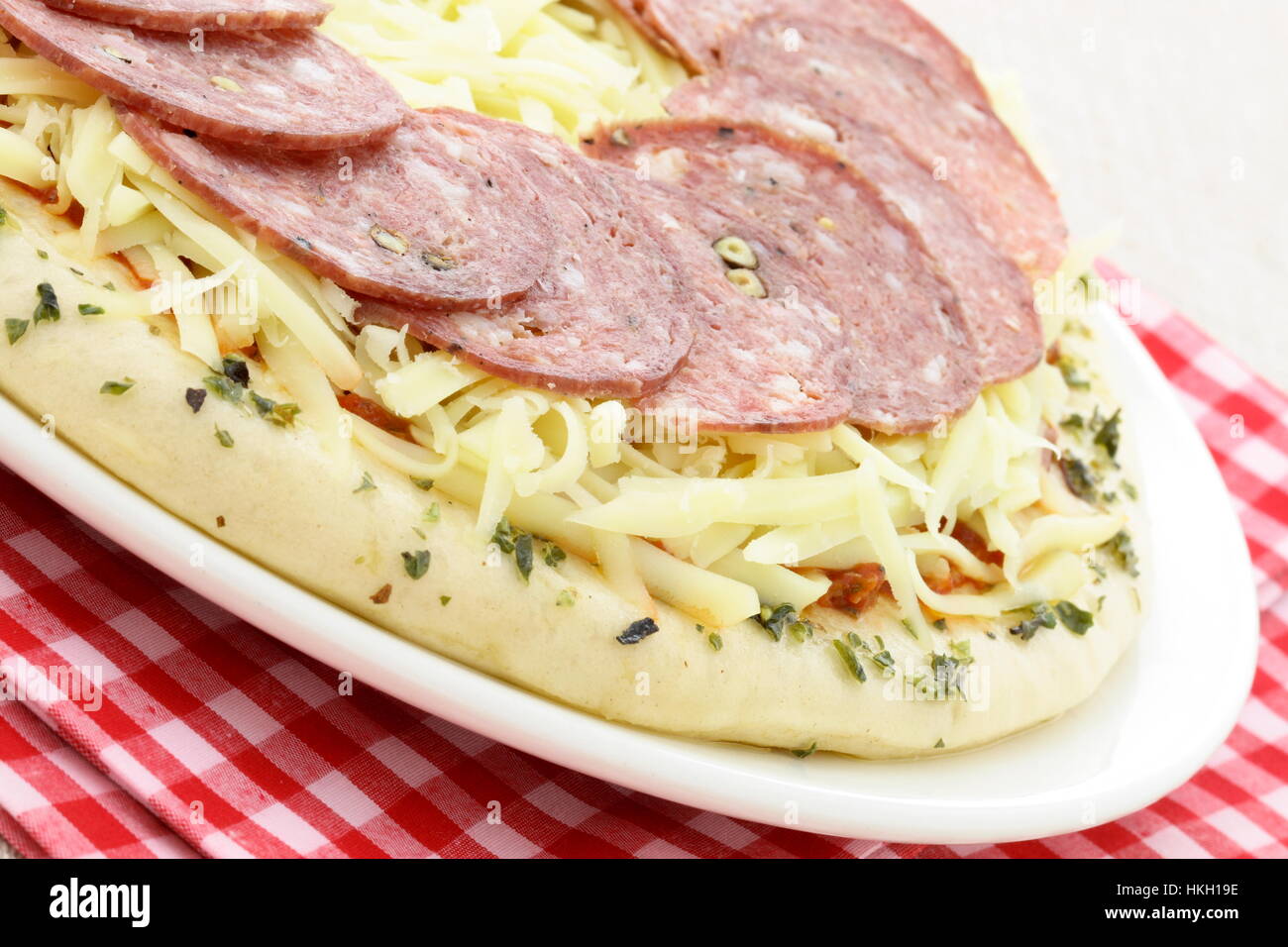 ready to bake delicious rustic salami and cheese pizza Stock Photo - Alamy