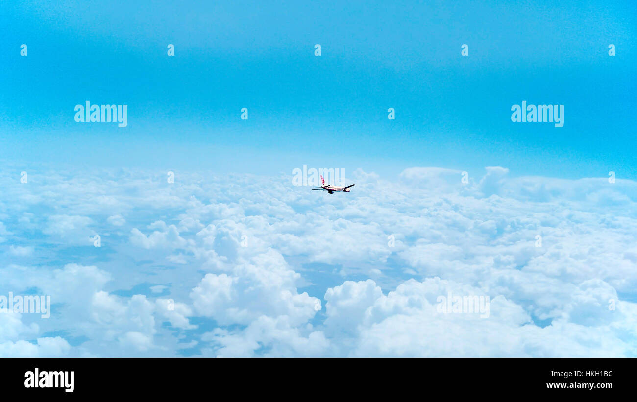 A flying plane in the sky Stock Photo