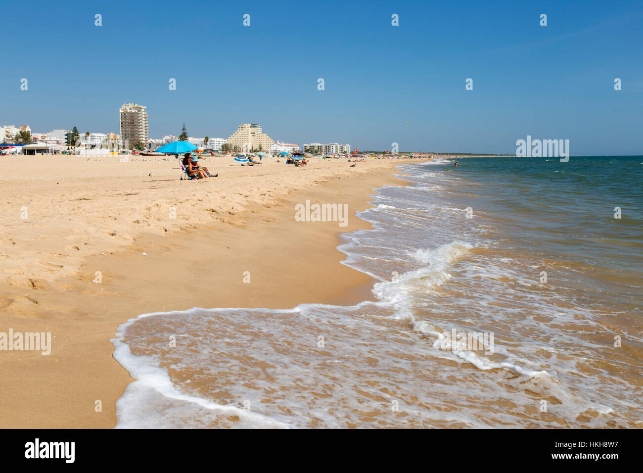View along white sand beach with resort behind, Monte Gordo, Algarve, Portugal, Europe Stock Photo