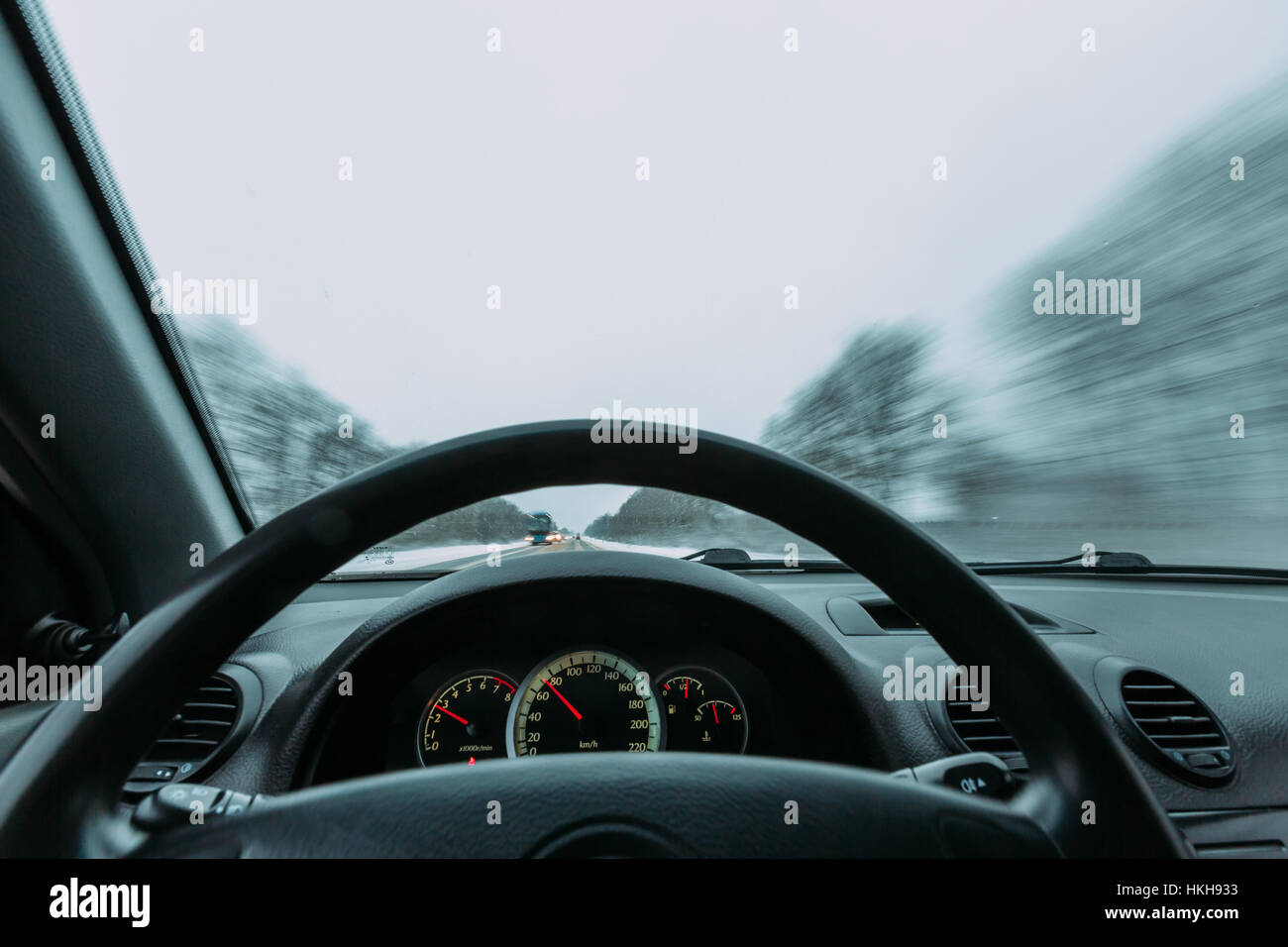 Riding behind the wheel of a car in winter Stock Photo
