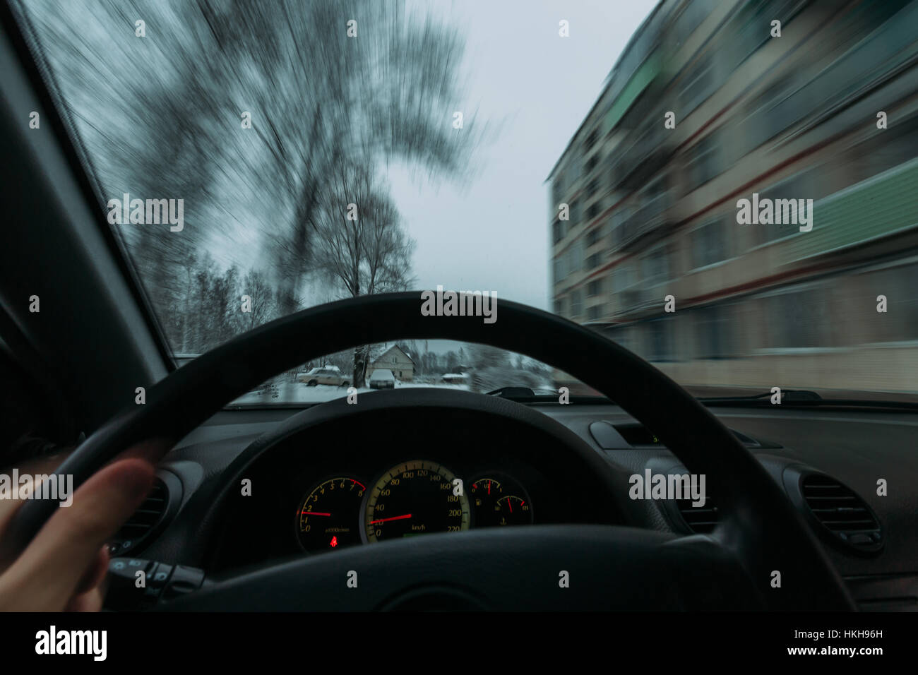 Riding behind the wheel of a car in winter Stock Photo