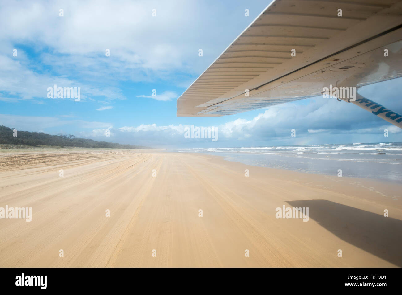 An airplane taking off from 75 Mile Beach on Fraser Island, Queensland Australia Stock Photo