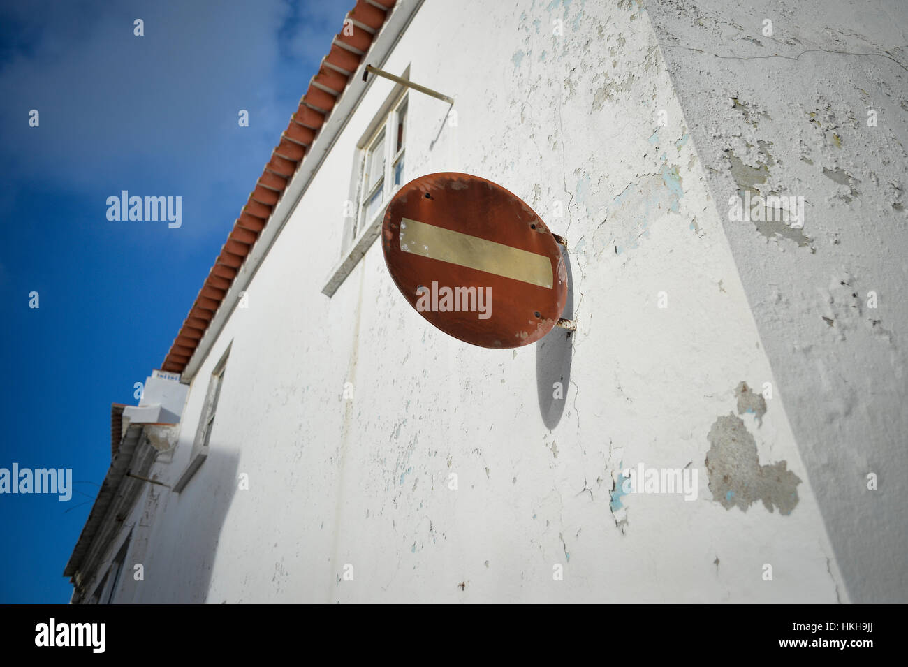 Stop sign on a white wall Stock Photo