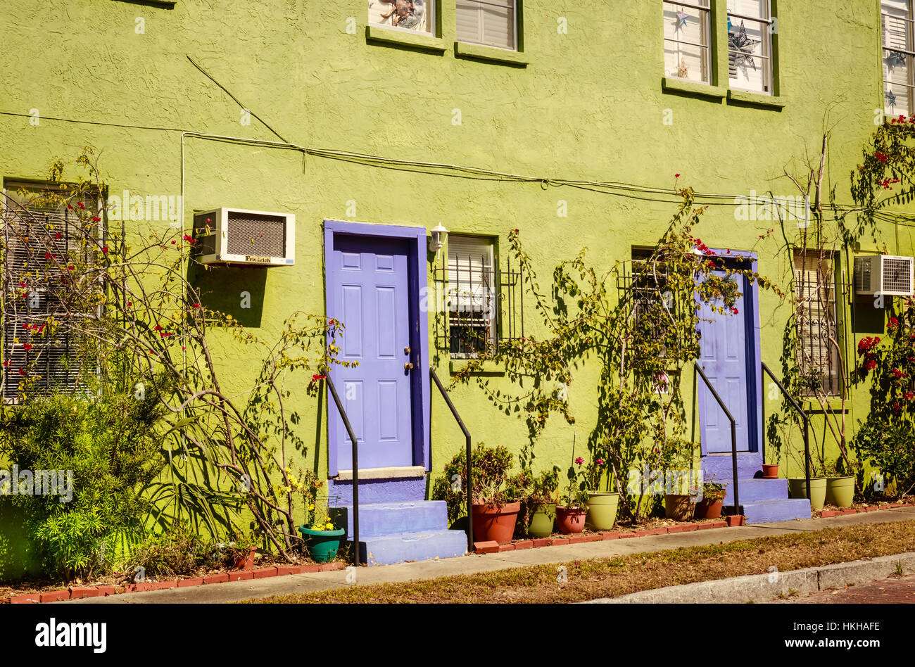 Brightly painted lime green exterior of residential townhouse in Gulfport, Florida Stock Photo