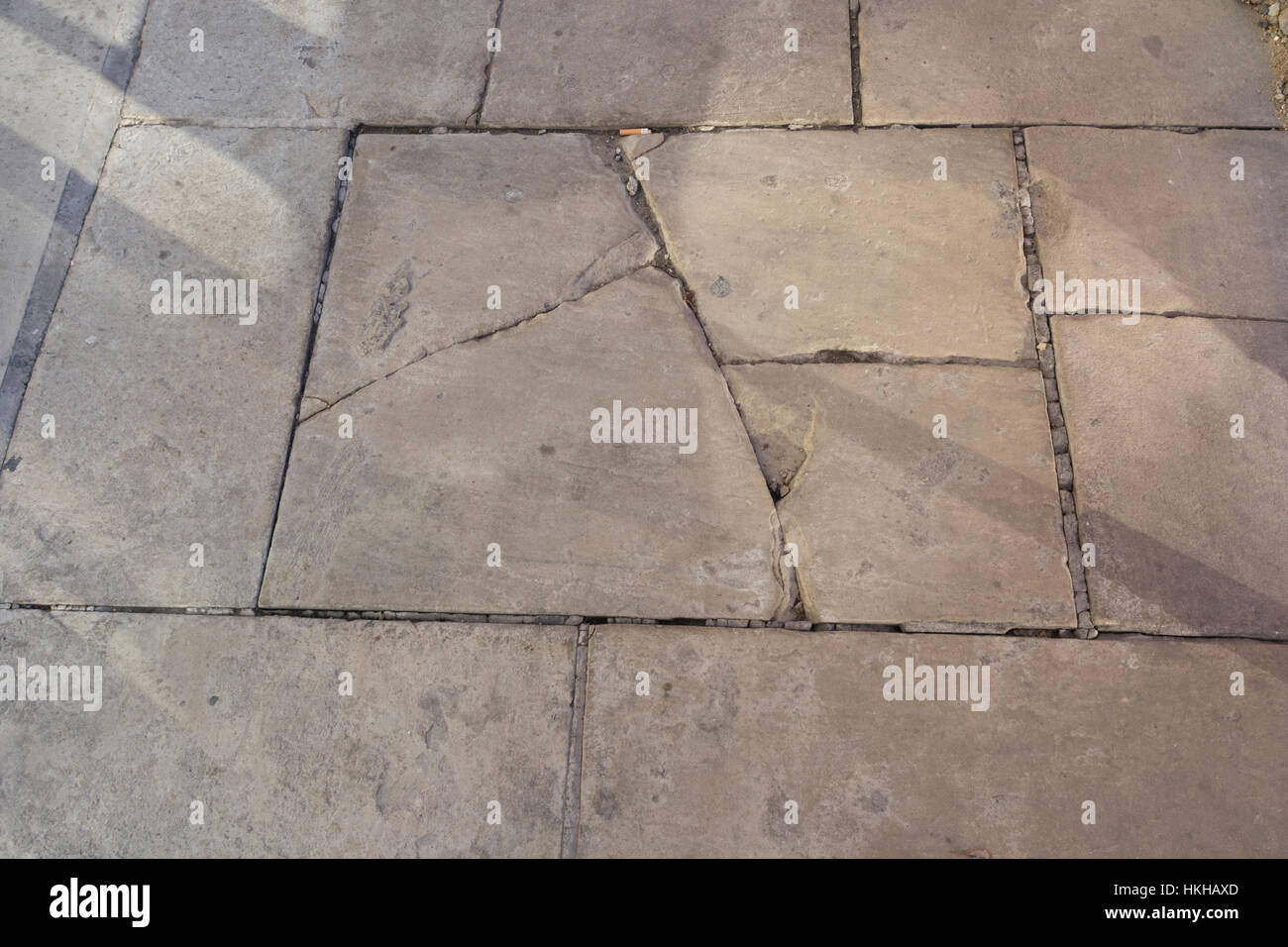 Cracked flag stone / flagstones in pavement along London's River Thames