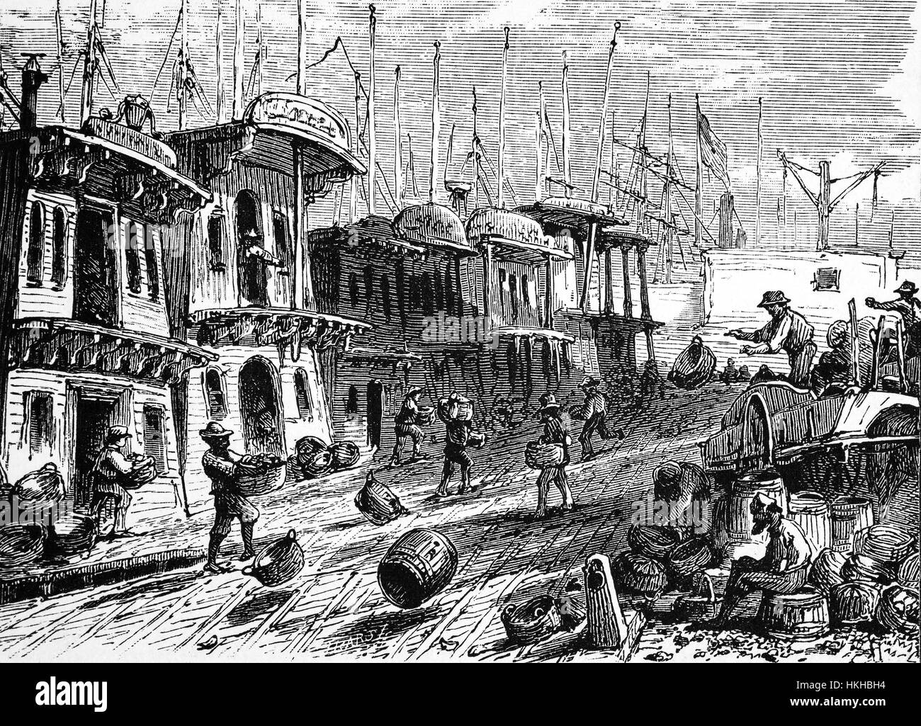 1879:  Oyster Boats tied up during  the oystering heyday from 1880 until about 1910. “Boat stores” popping up along the shore line from where oysters would be carted off to various parts of New York City to be sold. New York State, United States of America. Stock Photo