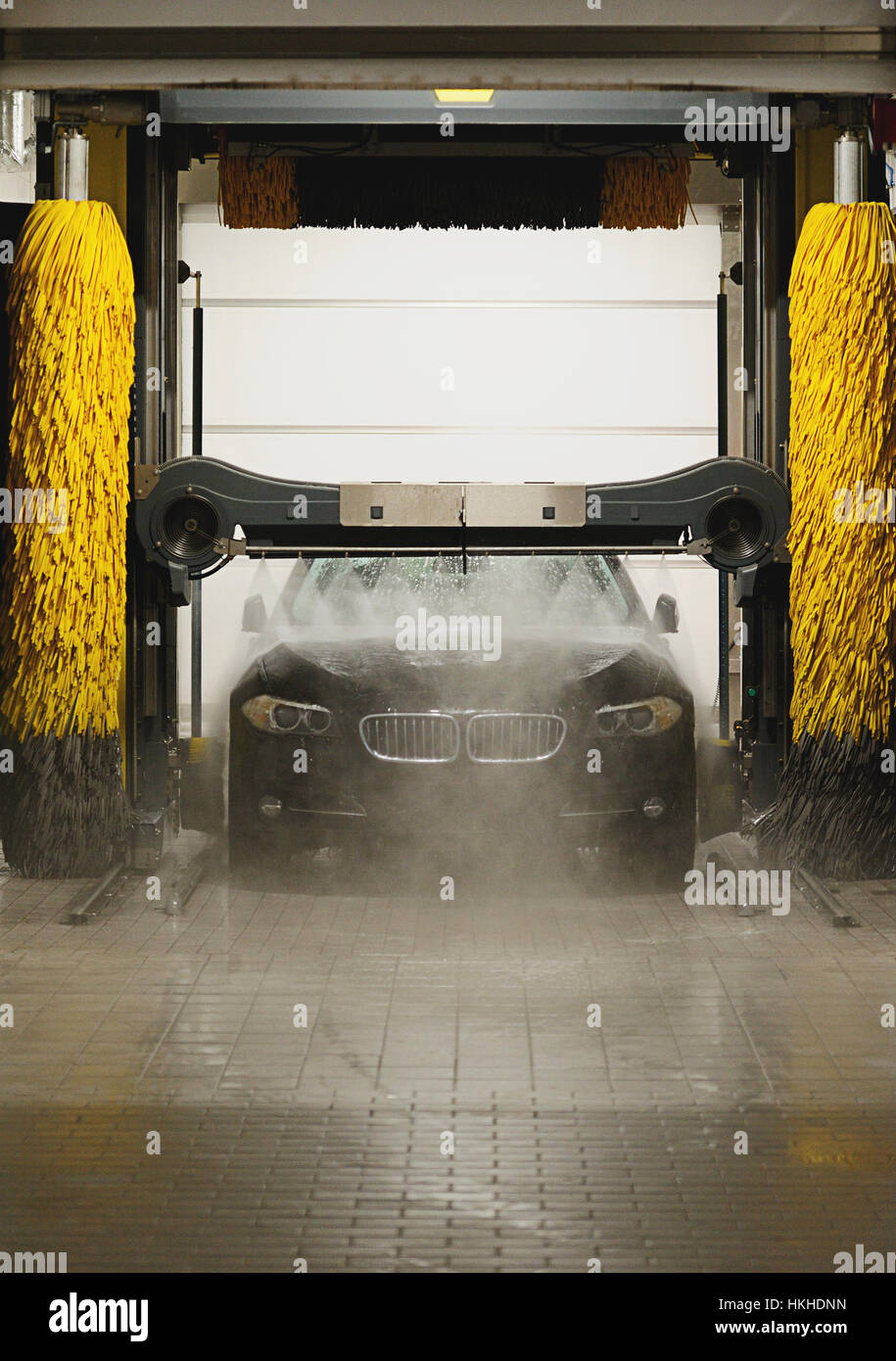 Black Car Spraying With Water In Station Washing Tunnel Stock