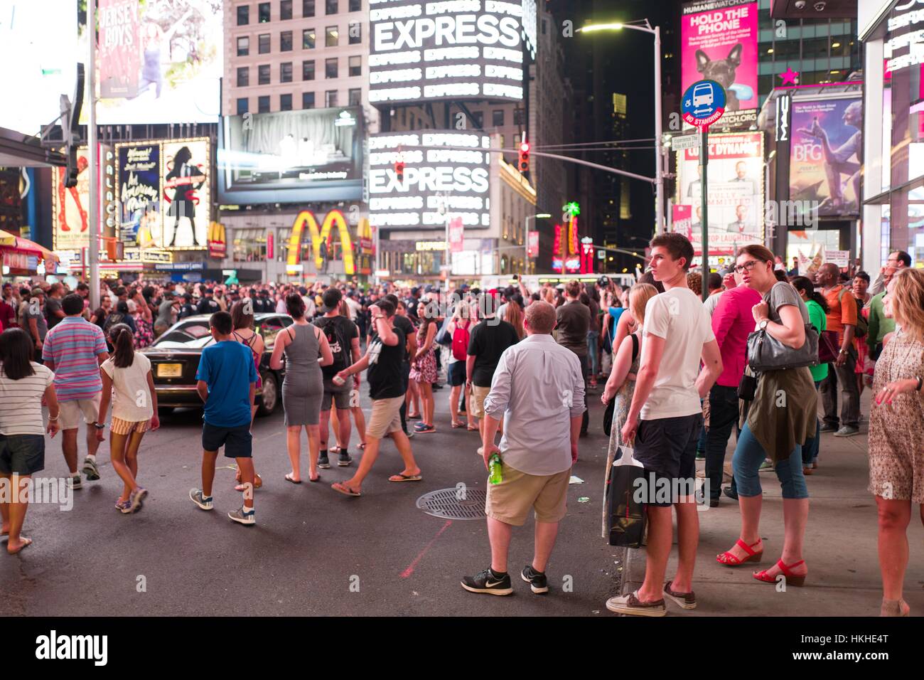 During a Black Lives Matter protest in New York City's Times Square following the shooting deaths of Alton Sterling and Philando Castile, activists block traffic and square off against a line of New York Police Department (NYPD) riot police as tourists look on, New York City, New York, July 7, 2016. Stock Photo