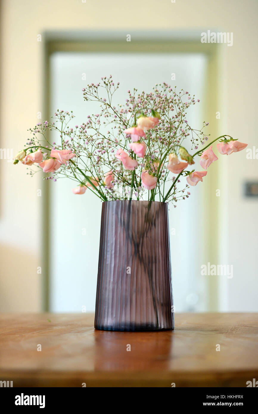 Pink cut glass vase with flowers in a room setting Stock Photo Alamy