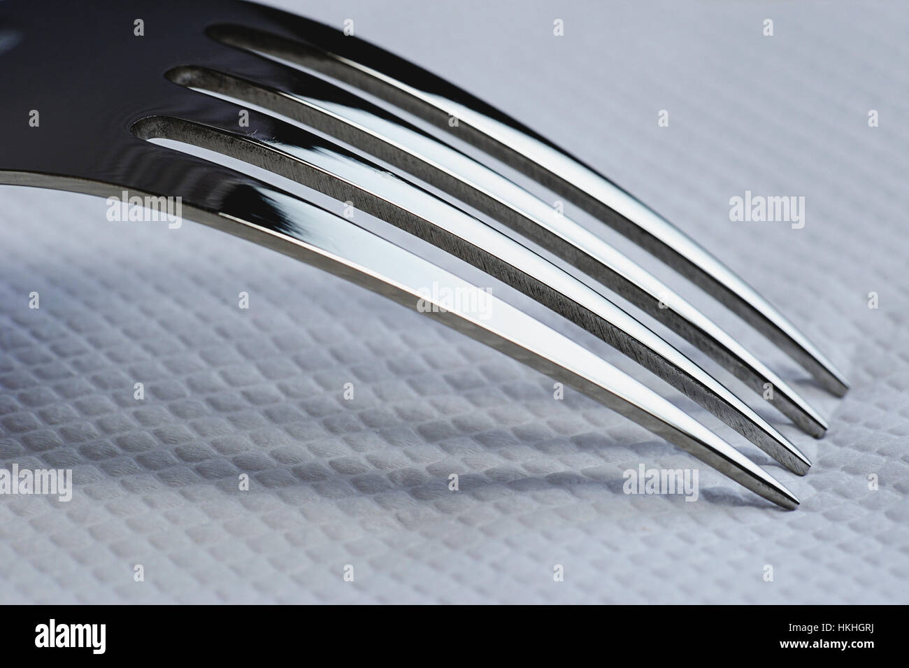 close up of shiny fork on white napkin Stock Photo