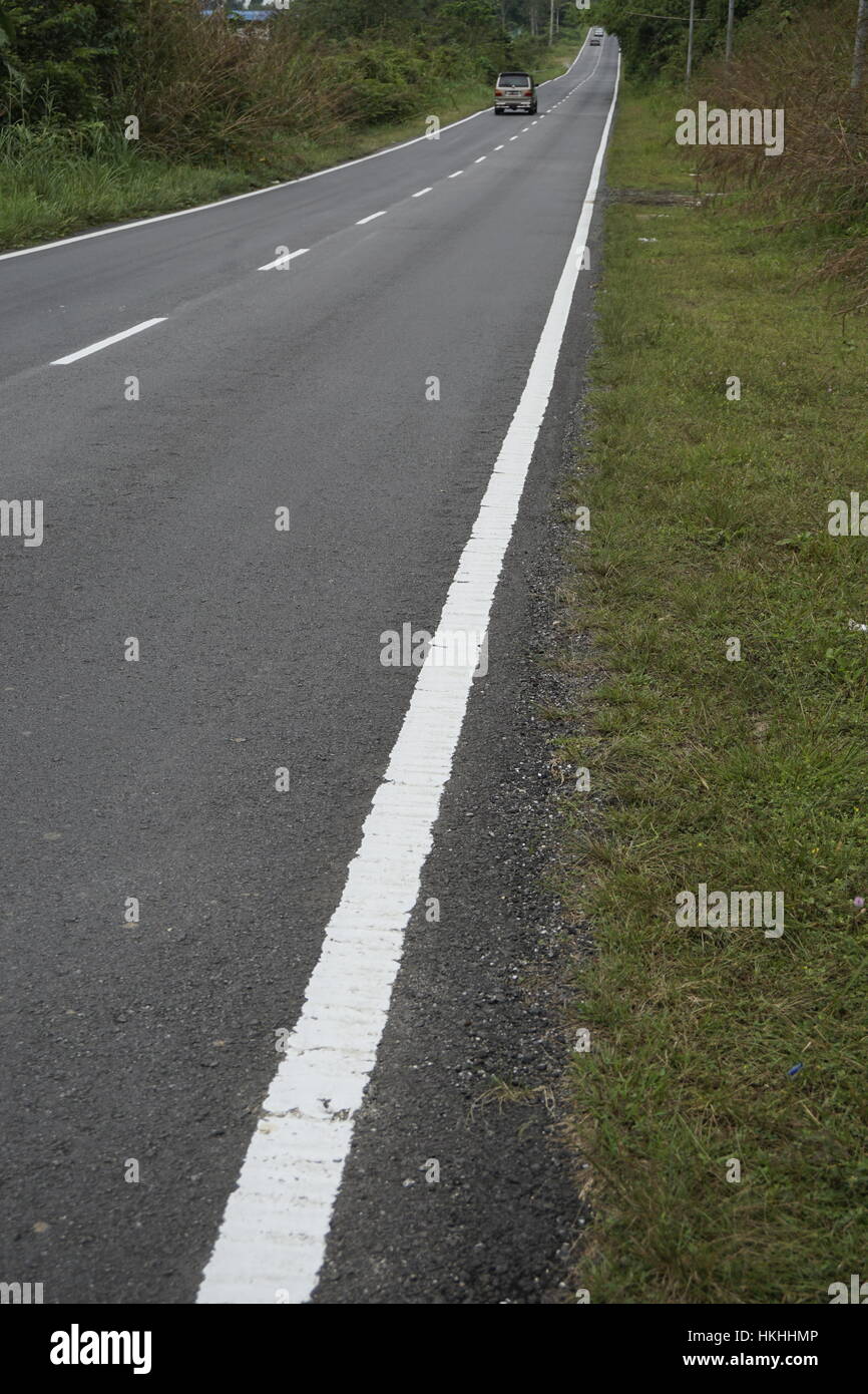 long stretch of road in rural area, Malaysia Stock Photo