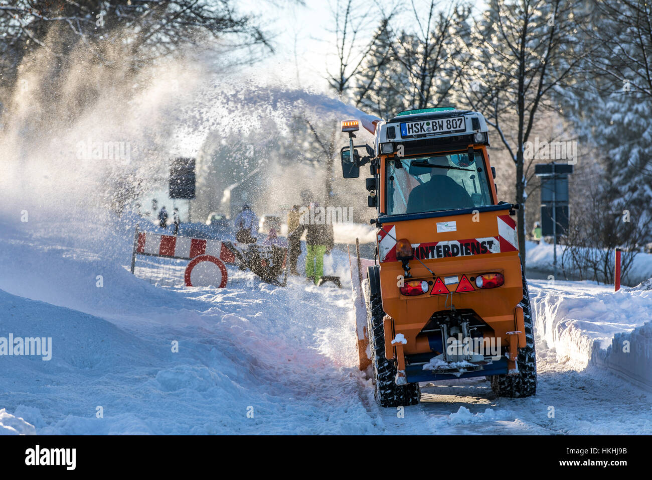 winter time in the Sauerland area, Germany, snow blower cleans a street, city of Winterberg, Stock Photo