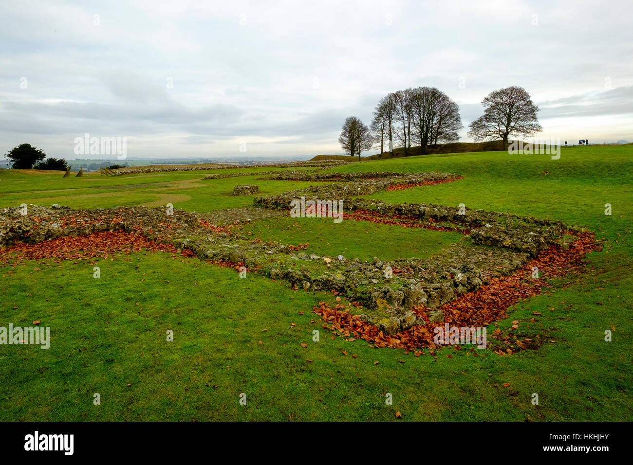 The ruins of the old cathedral within the grounds of Old Sarum, Salisbury stand in winter amidst red fallen leaves Stock Photo