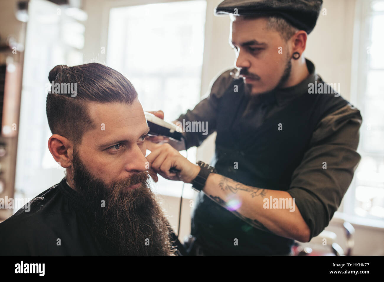 Handsome Young Bearded Man Getting Haircut In Salon Hairstylist