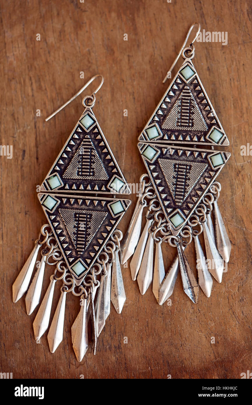 Beautiful Aztec earrings on wooden background Stock Photo - Alamy
