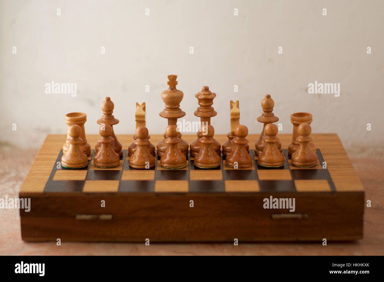 A half chess board with only the white chess pieces arranged facing the viewer Stock Photo