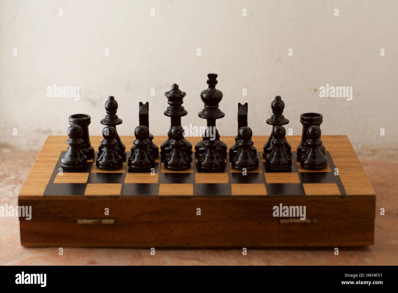 A half chess board with only the black chess pieces arranged facing the viewer Stock Photo