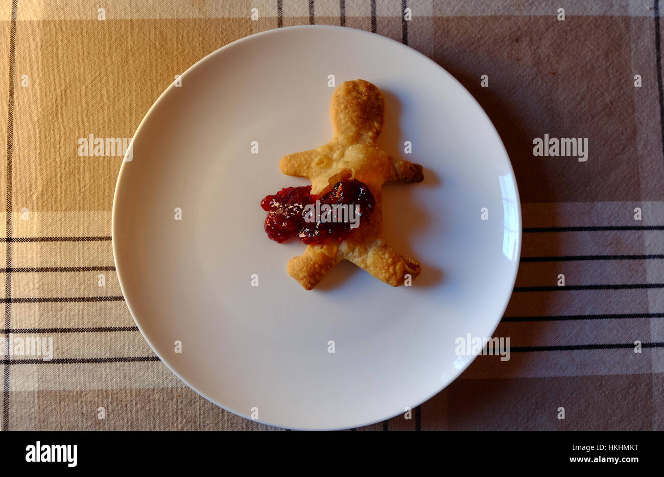Gingerbread man with horrific jam injury to his stomach Stock Photo