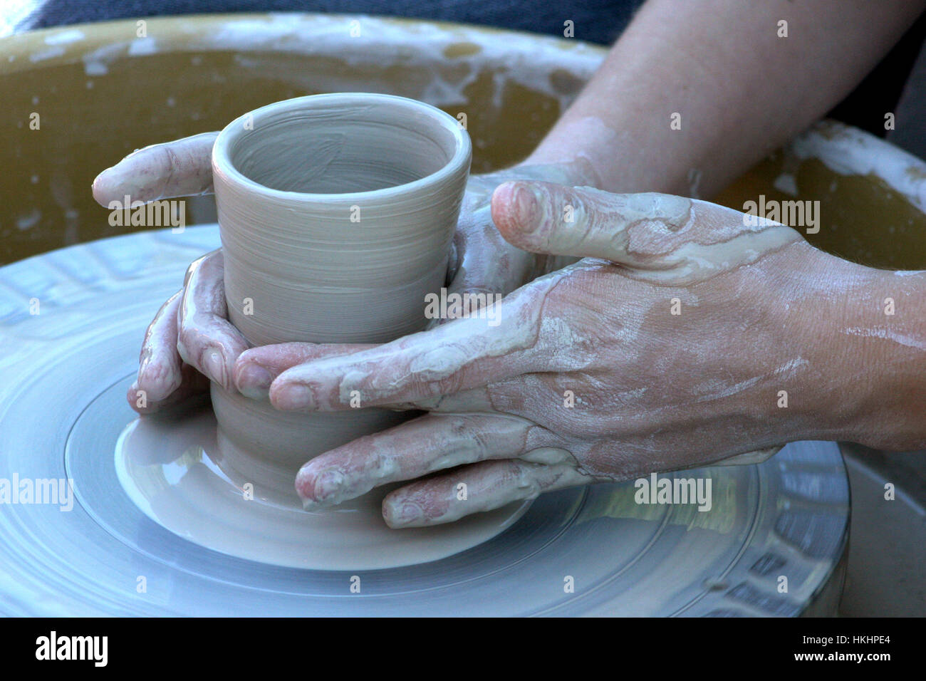 Close up on potter's hands shaping the clay on the wheel Stock Photo ...
