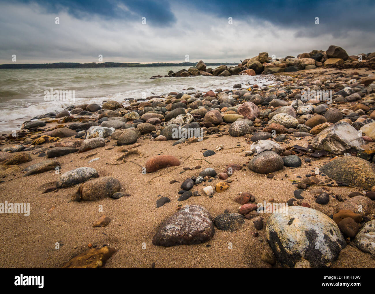 Rocky Beach Under A Cloudy Sky Stock Photo - Alamy