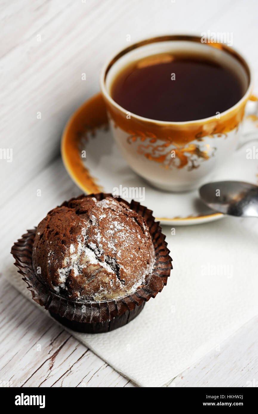chocolate cupcake with cup tea  on white wood table Stock Photo