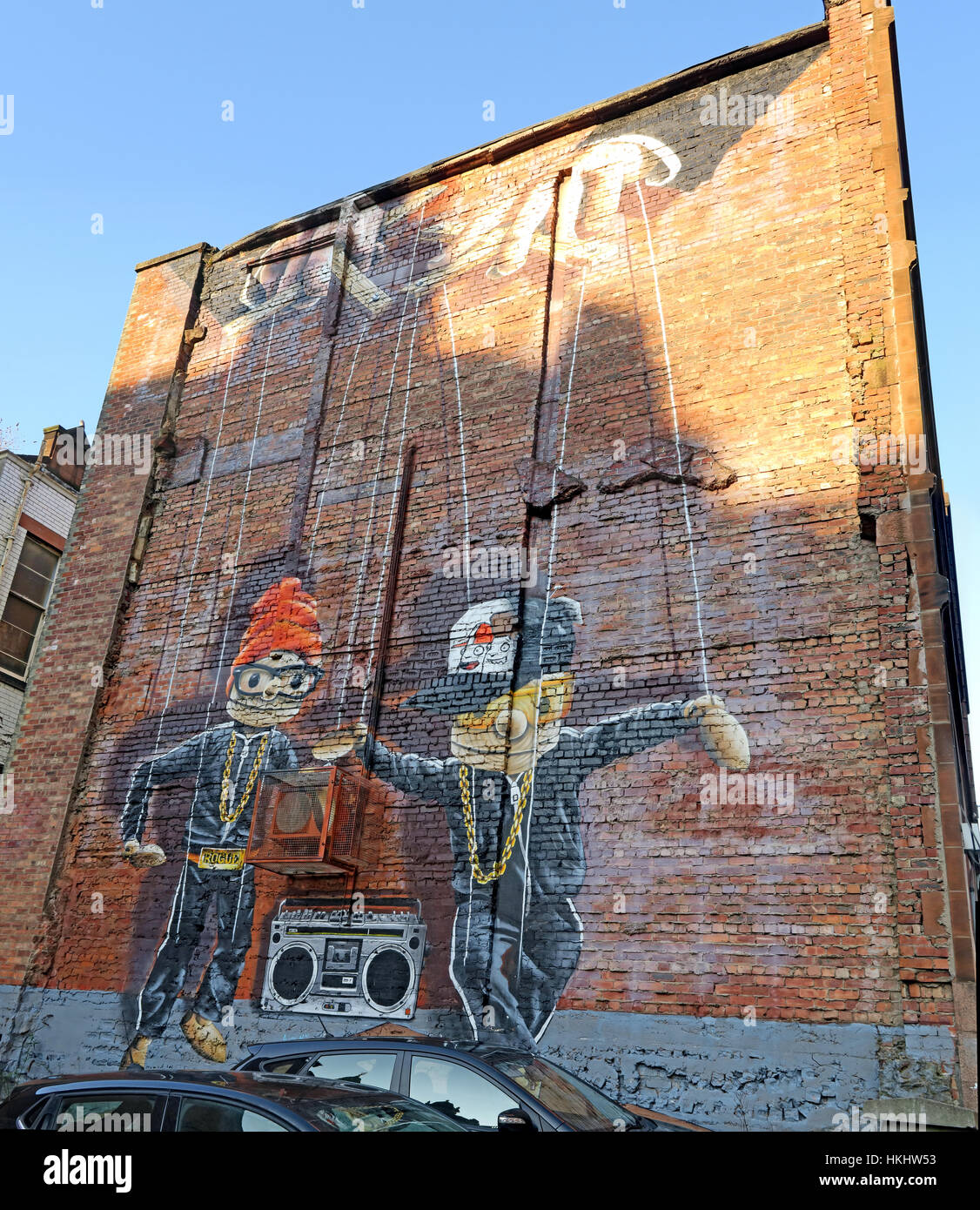 Art on a gable-end wall in Glasgow city centre, depicting two puppets dancing to music, Scotland, UK Stock Photo