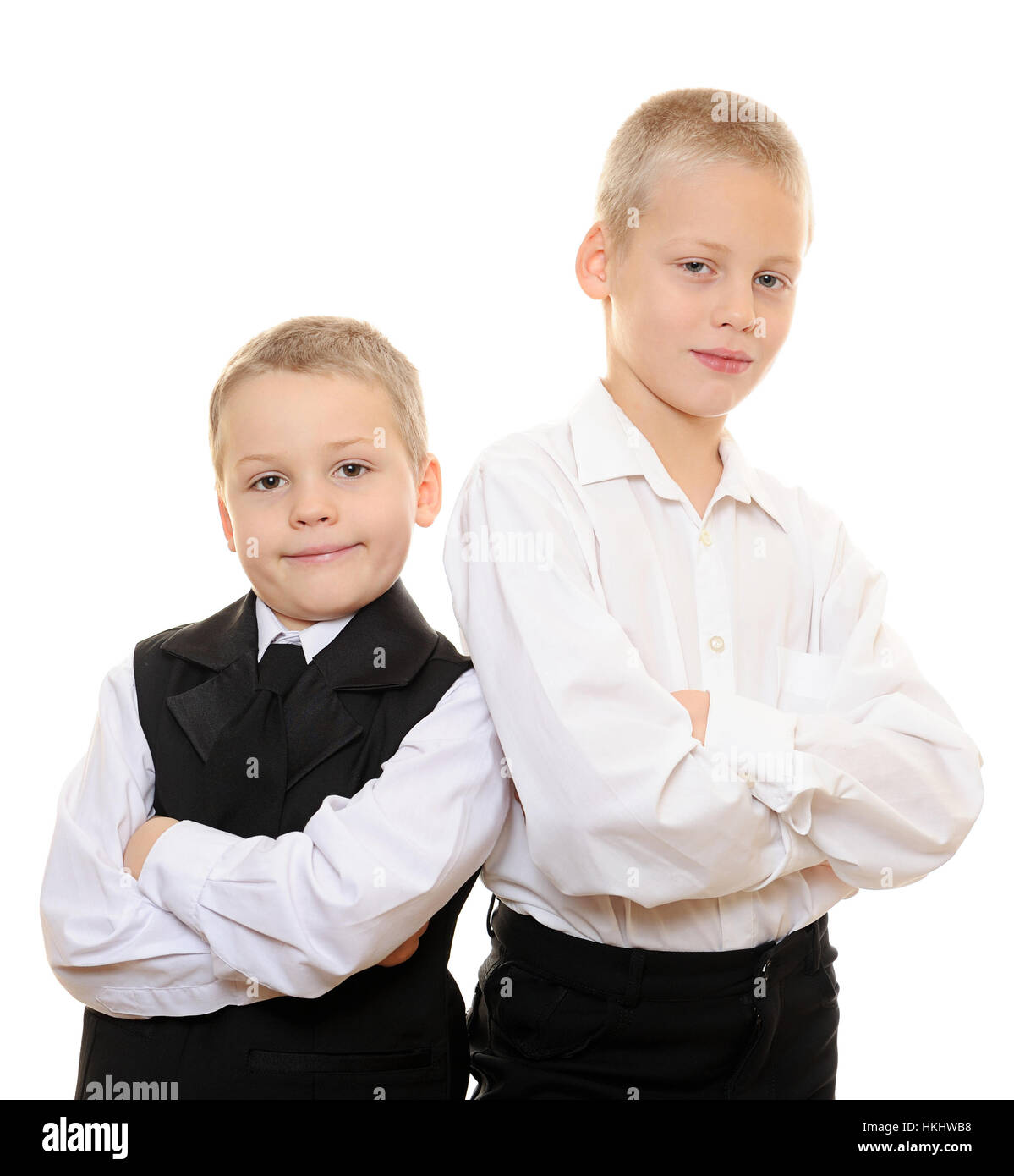 kids back to back in suit on white isolated Stock Photo