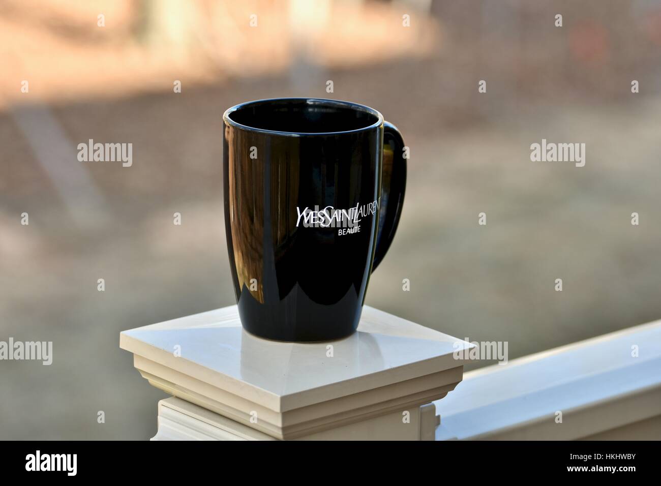 A black coffee mug representing the Yves Saint Laurent brand Stock Photo -  Alamy