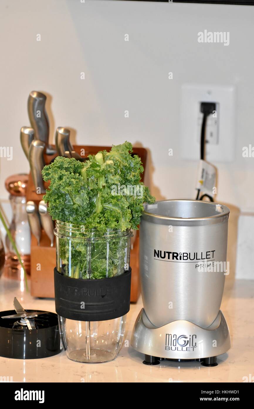 Kale stuffed and over filling a blender Stock Photo Alamy