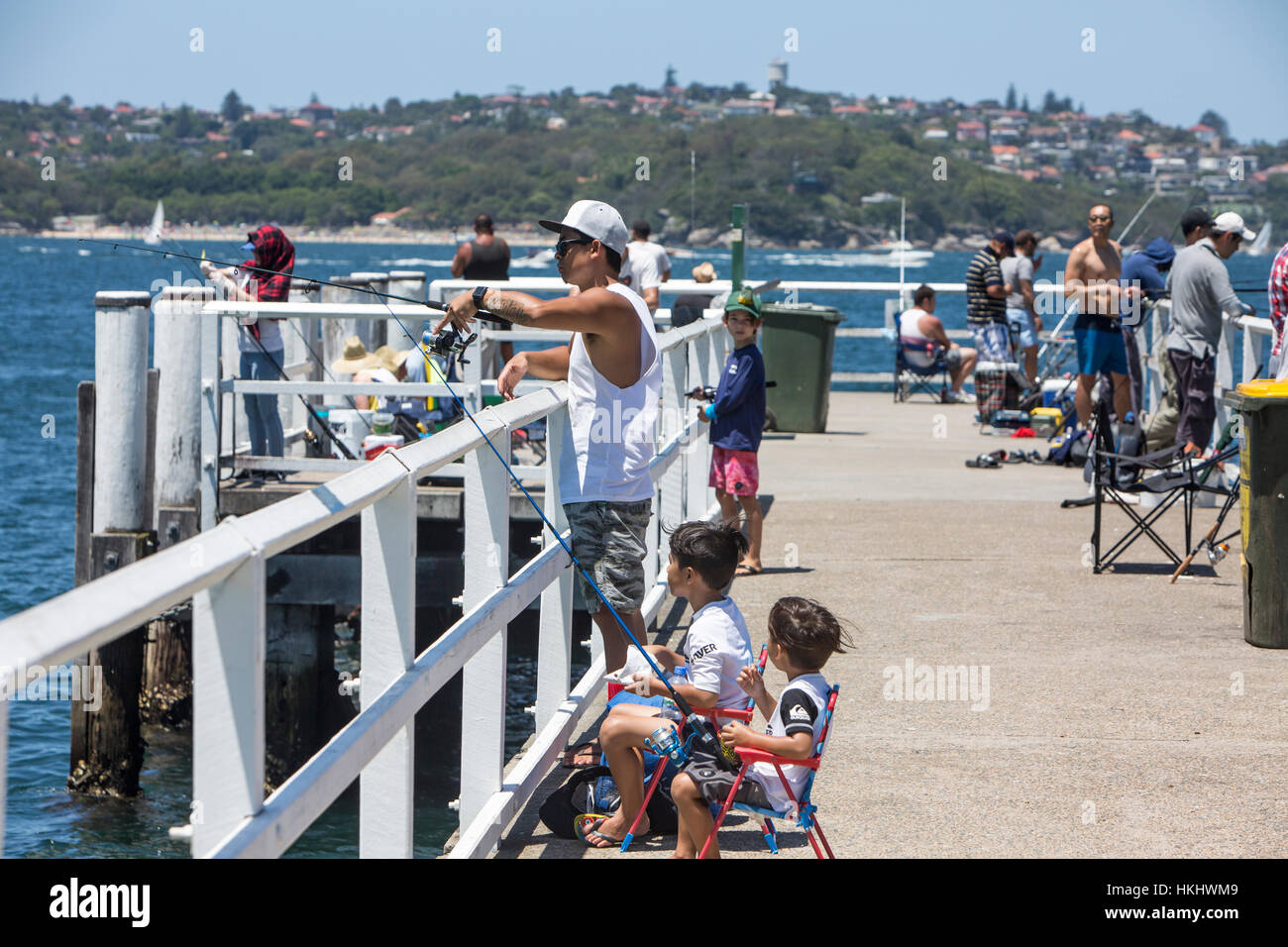 Parents and children fishing from the jetty in Chowder Bay,Sydney