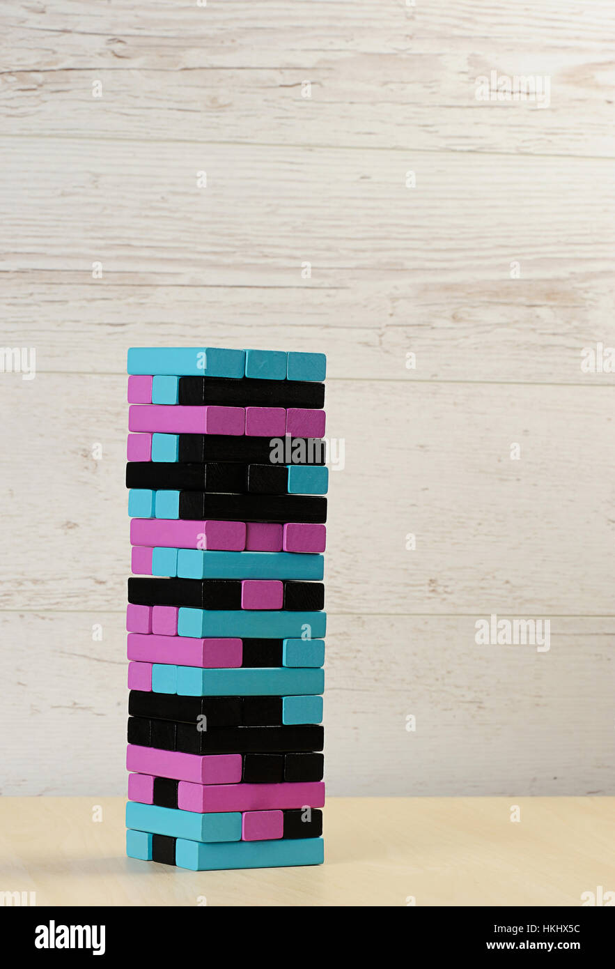 jenga tower colour stay on wood table Stock Photo
