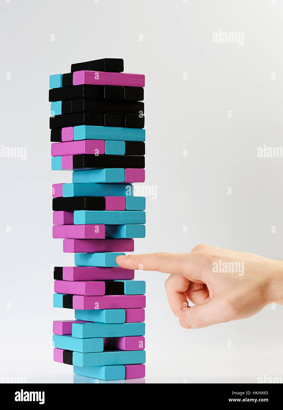hand pull tall jenga color tower block Stock Photo