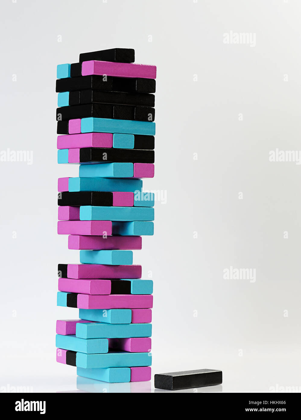 color jenga tower with brick on white Stock Photo