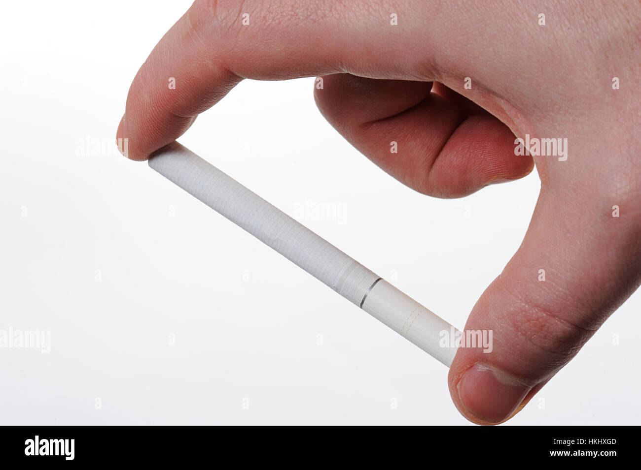 cigarette on hand hold with fingers isolated on white Stock Photo