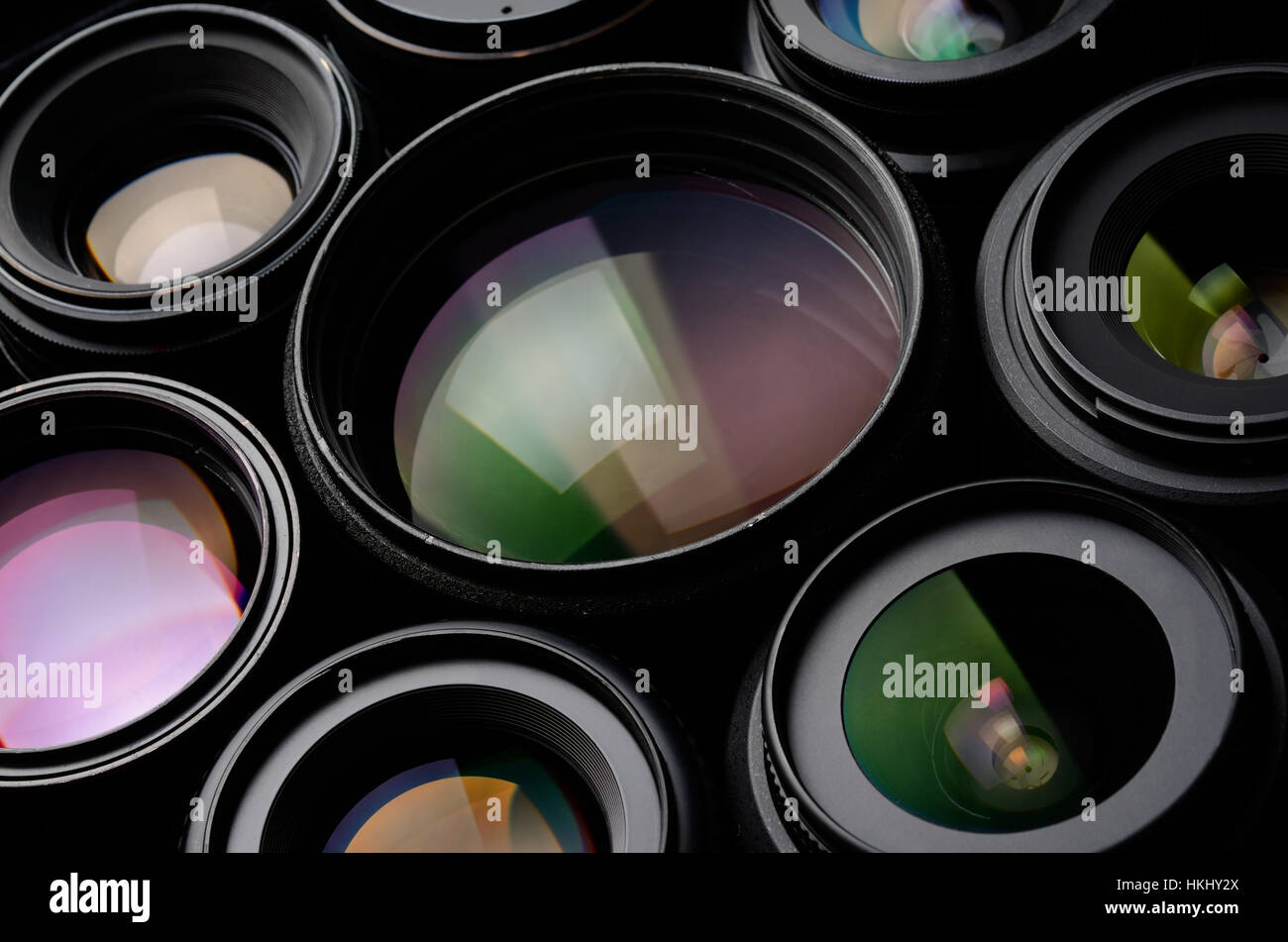 Set of black camera lens different sizes and colors macro shot Stock