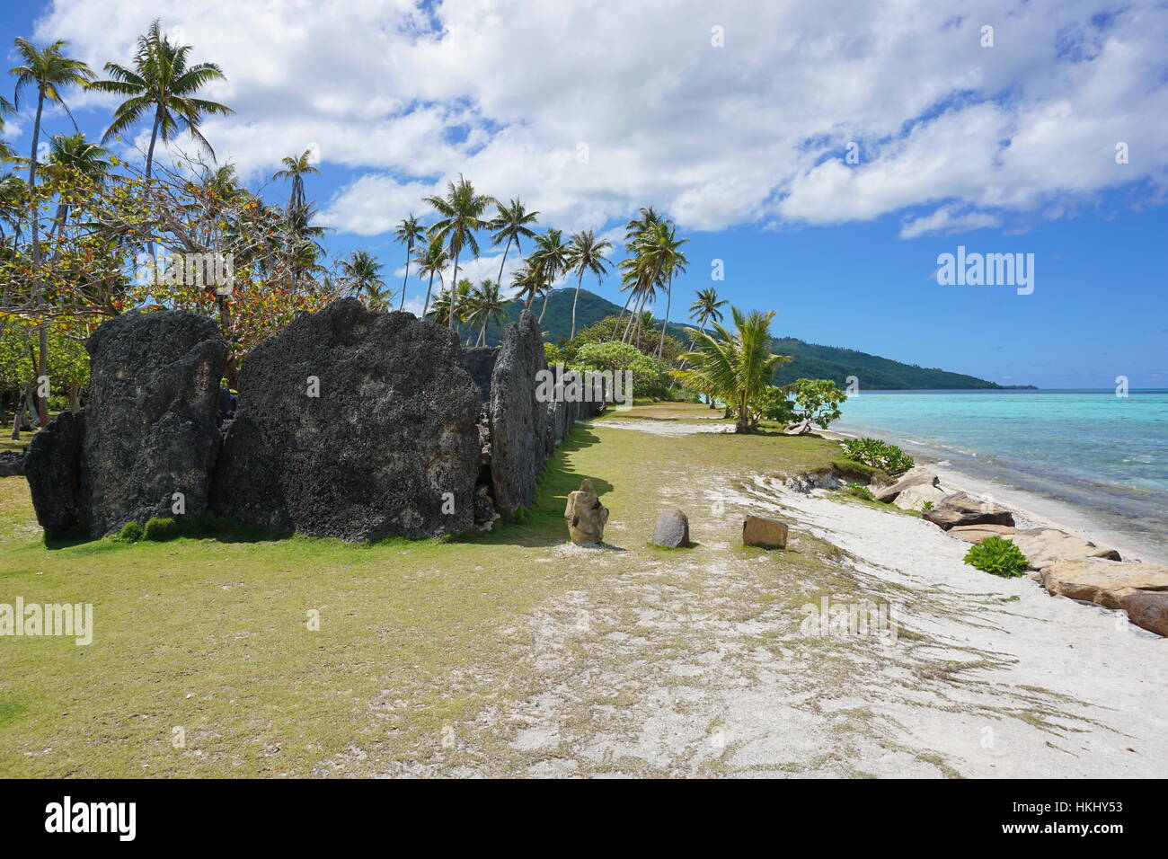 Tropical shore with ancient stone structure, the marae Anini on the south of the island of Huahine Iti, French Polynesia Stock Photo